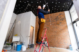 Electrician Installer With A Tool In His Hands, Working With Cab